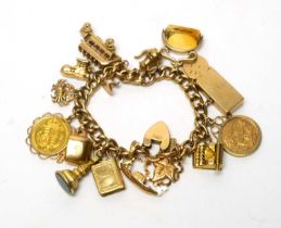 A 15ct yellow charm bracelet with two half sovereign charms and others