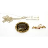 A Victorian mourning brooch, an Edwardian bar brooch, and a silver ingot pendant