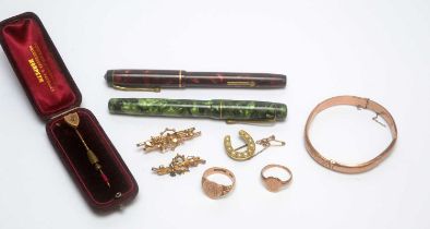 A 9ct yellow gold bangle, and two fountain pens