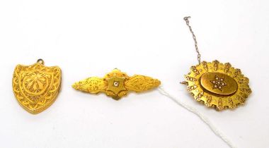 Two Victorian 15ct yellow gold brooches; and a locket