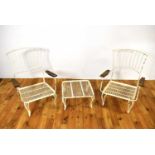 A pair of vintage white painted wrought metal garden easy chairs.