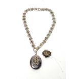 A Victorian silver locket pendant on chain; and a brooch