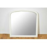 A contemporary arched overmantel mirror painted in a white colourway