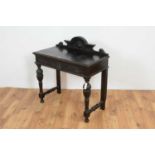 A Victorian carved and ebonised oak hall table