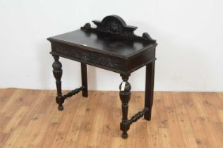 A Victorian carved and ebonised oak hall table