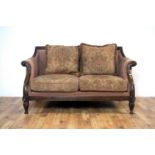 A William IV style sofa with carved foliate mahogany frame