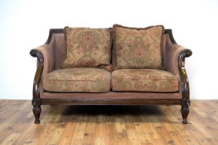 A William IV style sofa with carved foliate mahogany frame