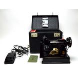 A Singer 221K Portable electric sewing machine