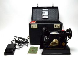 A Singer 221K Portable electric sewing machine