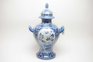 A Delft blue and white twin handled urn vase with cover