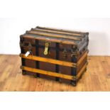 A vintage oak, brass and metal-bound cabin trunk,