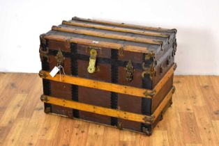 A vintage oak, brass and metal-bound cabin trunk,