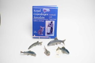 Four Royal Copenhagen ceramic fish figures; and a collectors guide