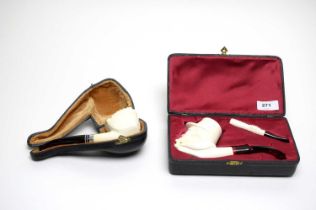 A cased meerschaum pipe; and another