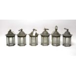 A set of six pewter lanterns with associated wall supports