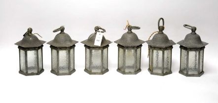 A set of six pewter lanterns with associated wall supports