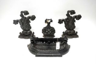 Three cast iron door stops; and a cast iron boot scraper