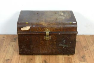 A vintage metal travelling trunk in a painted simulated wood finish.