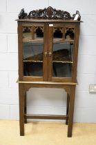 A 20th Century oak display cabinet on stand