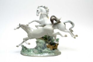 A Lladro decorative ceramic figure group of Horses Galloping