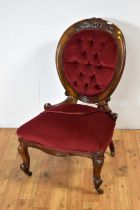 A Victorian carved walnut easy chair