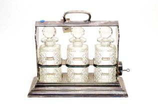 A silver plated three bottle tantalus