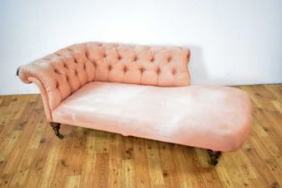 A Victorian chaise longue upholstered in salmon pink fabric