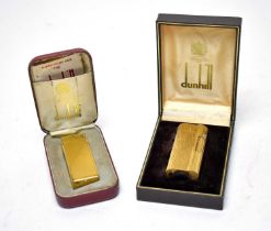 A Dunhill ‘S’ gilt metal cigarette lighter; and another