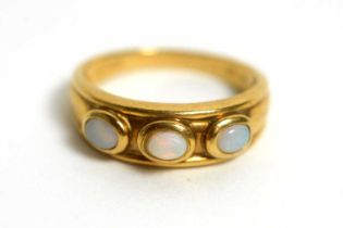 A three stone opal cabochon ring