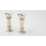 A pair of George V arts and crafts silver vases with flaring rims