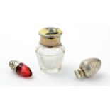 A George V silver mounted cut-glass smelling salts bottle; and two others