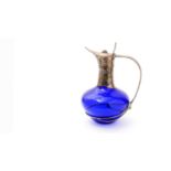 A contemporary silver-mounted blue glass claret jug