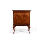 A burr walnut cabinet on stand