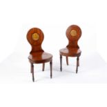 A pair of early 19th Century mahogany hall chairs