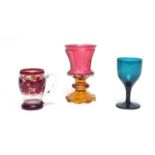 A Bohemian cranberry and amber glass goblet, ruby flash cup, green wine glass