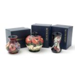 Three Moorcroft vases, boxed.