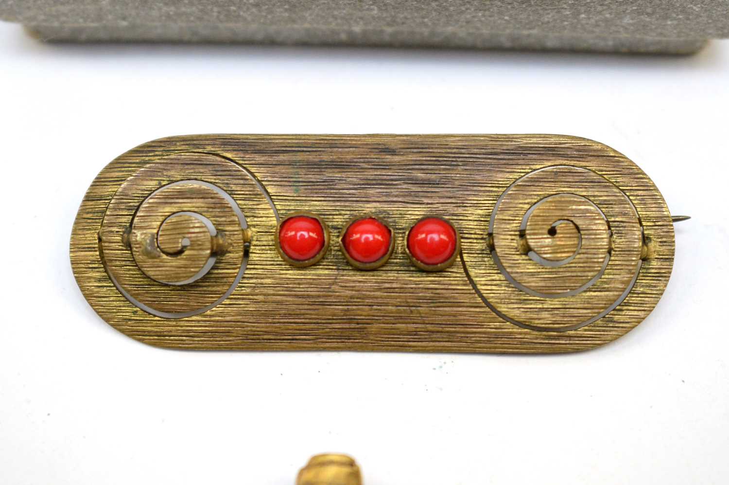 A 1920s brooch modelled as the head of a African lady, and a tribal bar brooch - Image 2 of 3