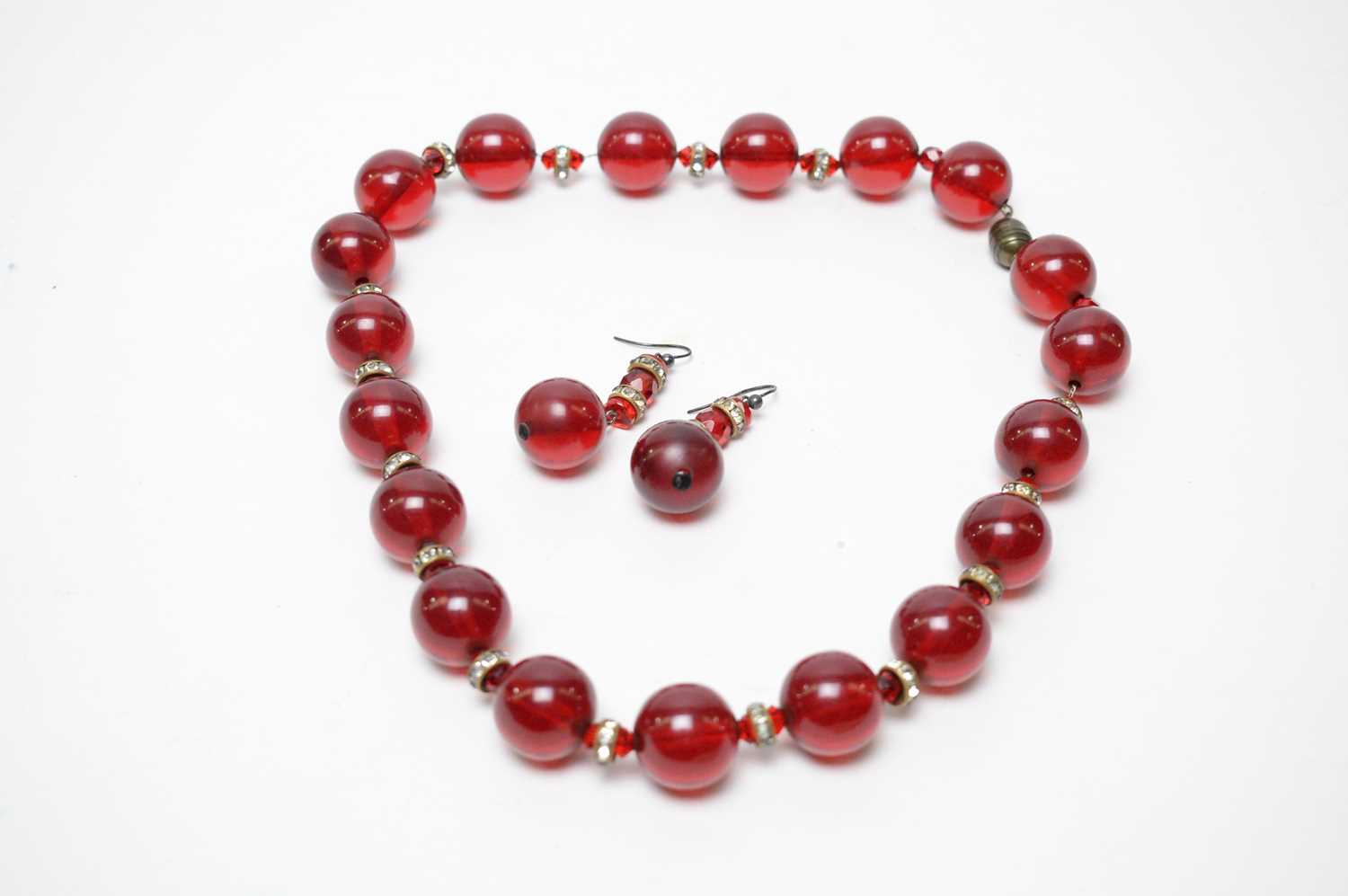 A 1930s Art Deco cherry-red lucite demi-parure