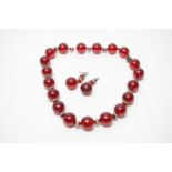 A 1930s Art Deco cherry-red lucite demi-parure