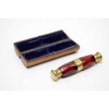 A Victorian novelty ruby faceted double-ended scent bottle, forming the shape of opera glasses