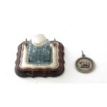 A silver mounted glass inkwell and a medal
