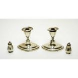 A pair of silver candlesticks, a pair of silver Siam pepperettes