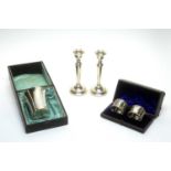 A French silver beaker, candlesticks and napkin rings