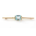 A blue glass and 9ct yellow gold bar brooch