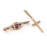 A 9ct yellow gold crucifix pendant on chain, and a garnet and 9ct yellow gold brooch