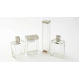 Four silver topped glass dressing table pots