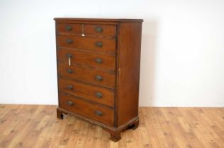 A 19th Century mahogany cupboard faced as a chest of drawers