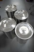 Four stainless steel twin handled milk cans or storage bins