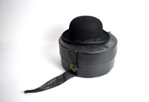 A Dunn & Co black bowler hat in a box