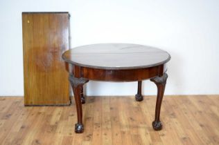 A 1920s mahogany extendable dining table